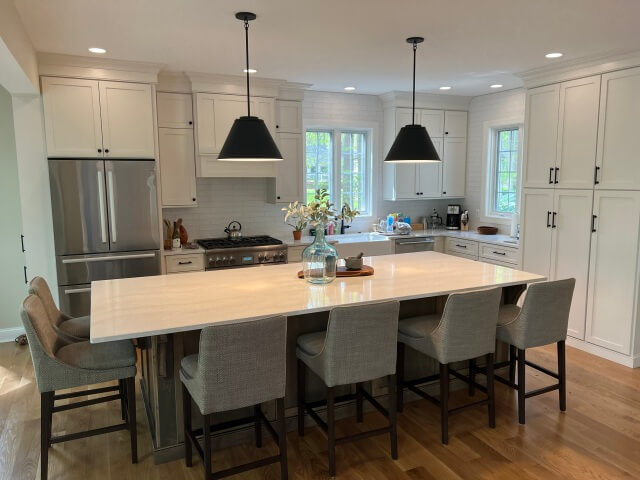 We removed the existing carpet and finished the hardwood floors beneath to match neighboring floors and create a warm, inviting living space.