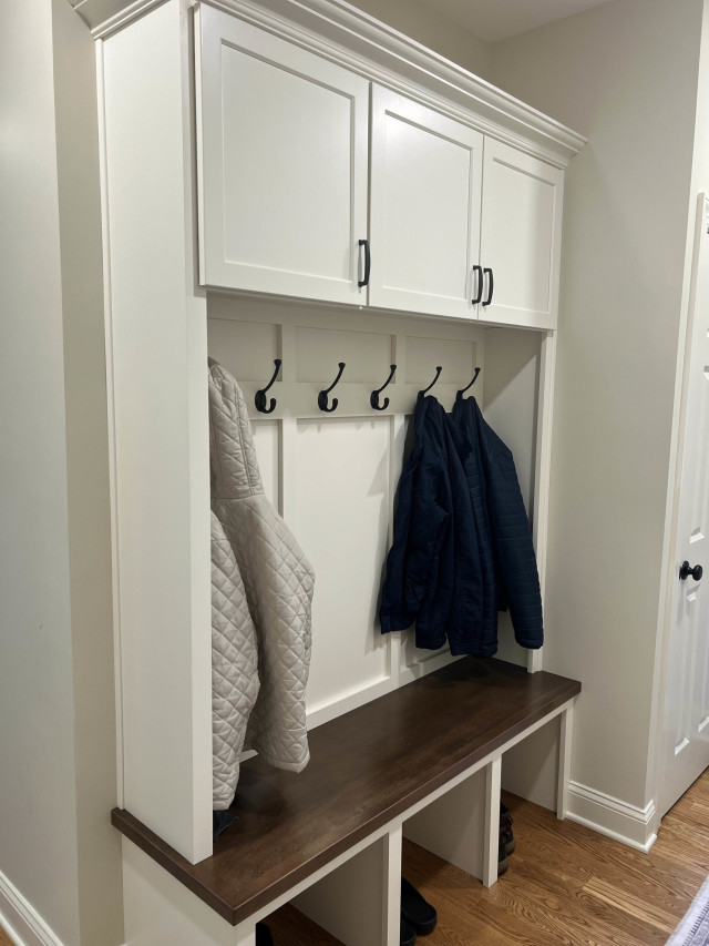 Custom Mudroom Bench and Storage
Built-in cabinetry and a wooden bench with boot space beneath provide organized storage and a warm, welcoming entryway.