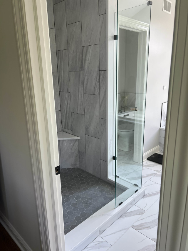 Shower with Modern Tile Design
We installed large-format tiles and a glass enclosure to make the shower feel more spacious and contemporary. Note the built-in shower seat.