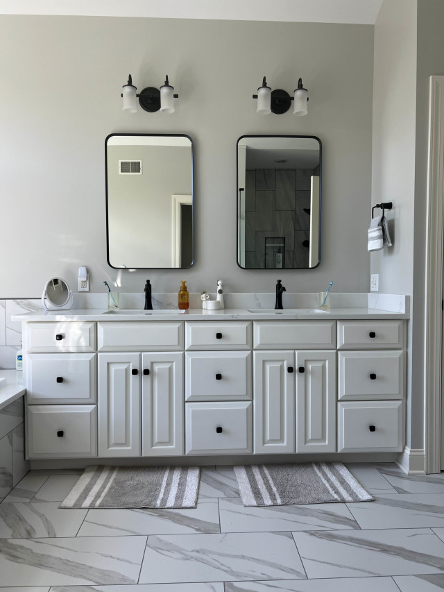 Double Vanity with Modern Mirrors and Fixtures
We were able to preserve the existing cabinetry and replace the large single frameless mirror with these charming framed pieces to great stylistic effect.