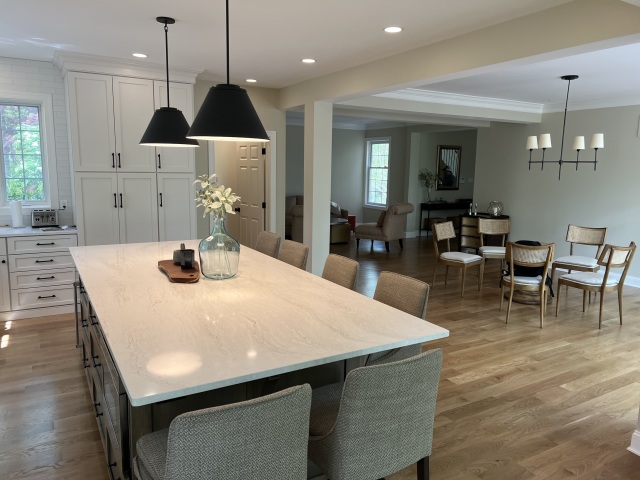 The refinished flooring extends seamlessly into the foyer, creating a cohesive transition from room to room.