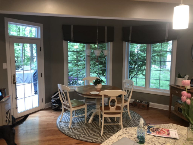 Custom-built-in cabinets and natural wood shelves frame the fireplace, blending storage with design while complementing the natural stone feature.