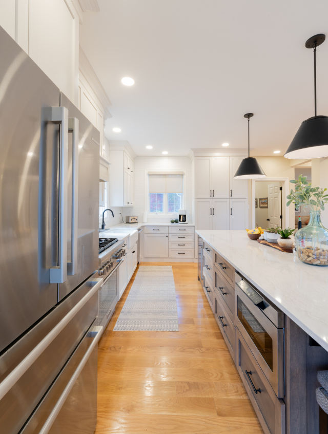 This built-in combines open shelving and cabinetry to provide practical storage and display options, enhancing the room’s functionality.