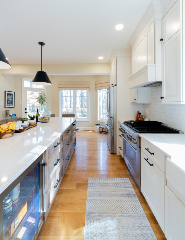 The refinished flooring extends seamlessly into the foyer, creating a cohesive transition from room to room.