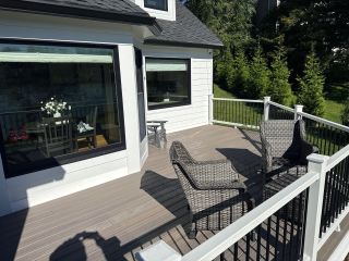 Composite deck, black railing and large windows outside a finished Landenberg home addition.