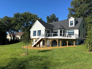 Rear exterior of Landenberg PA home showing completed addition, elevated deck and covered patio.